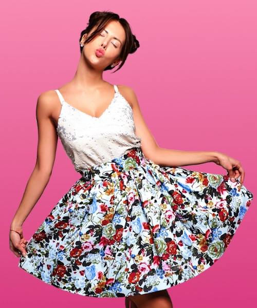 Brunette female model in white colored sleeveless top and retro pattern skirt