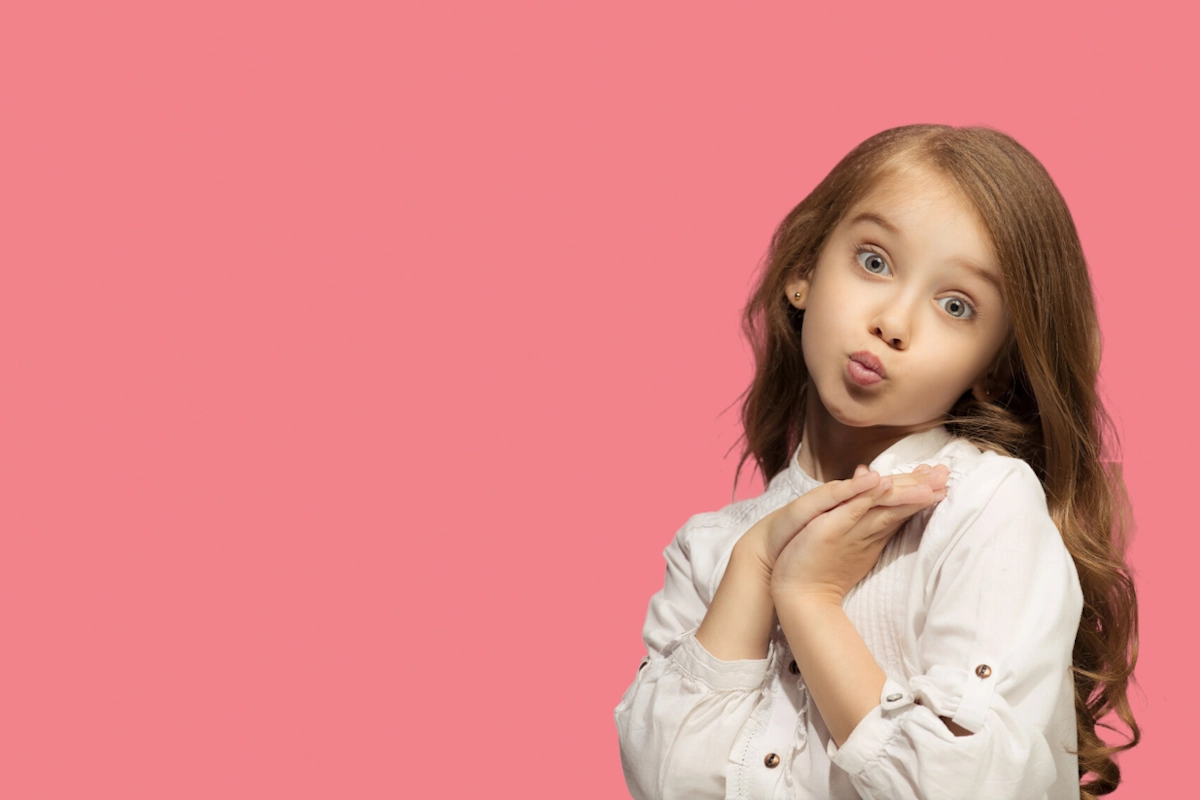 Caucasian young girl in white colored top making a funny face