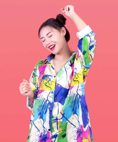 Chinese female model with happy face wearing colorful abstract pattern shirt