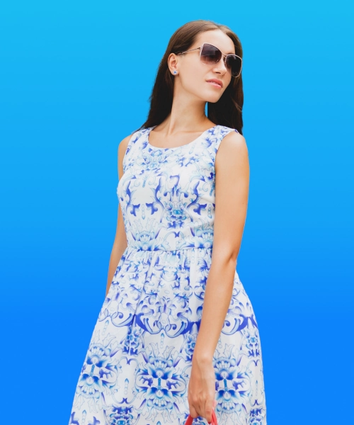 Female model with sunglass wearing a blue colored baroque pattern dress